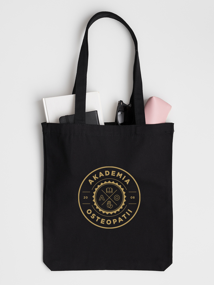 Black tote bag mockup with a notebook, book, glasses and case on